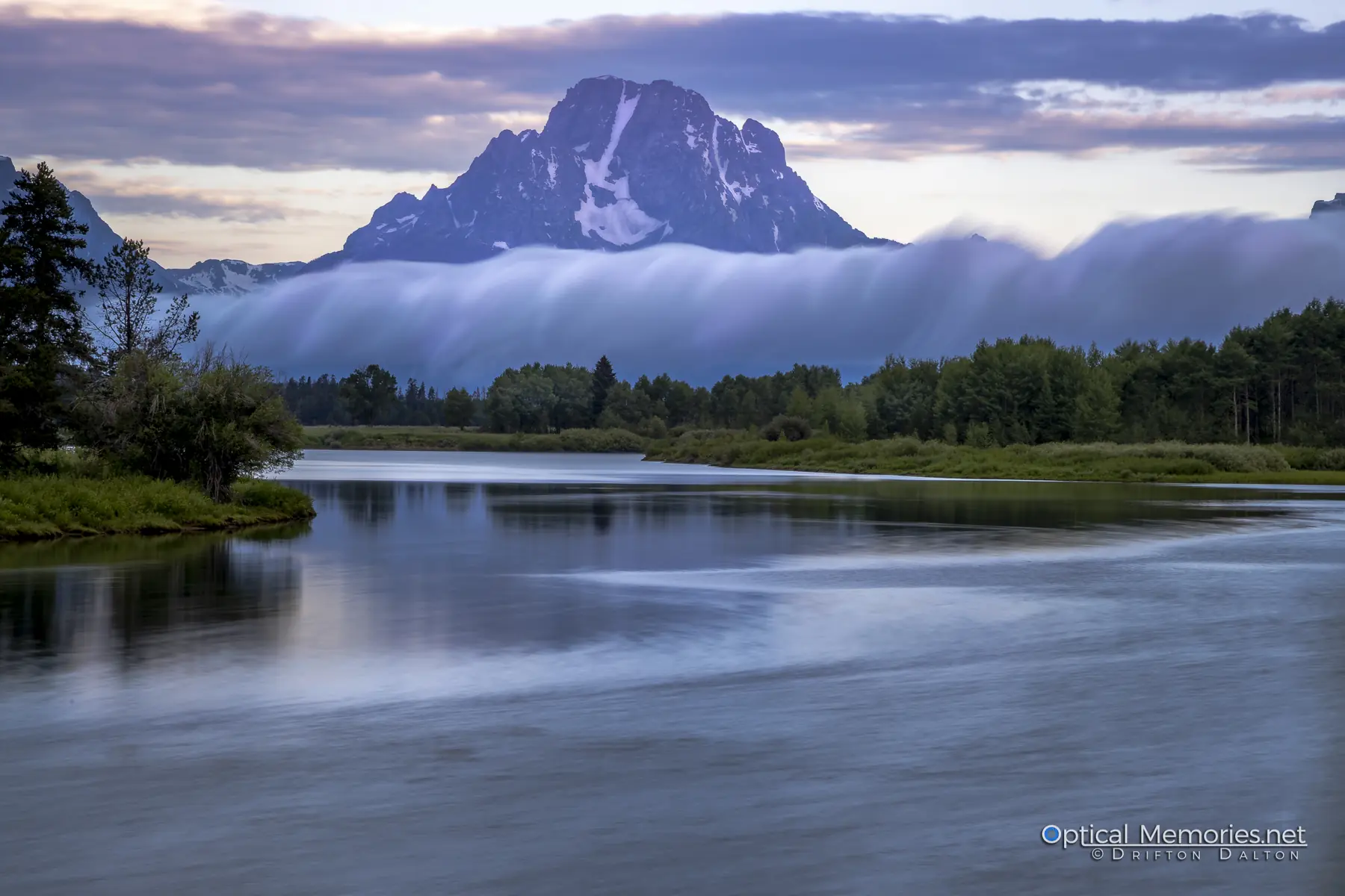Mount Moran rising above fog and calm water at Oxbow Bend
