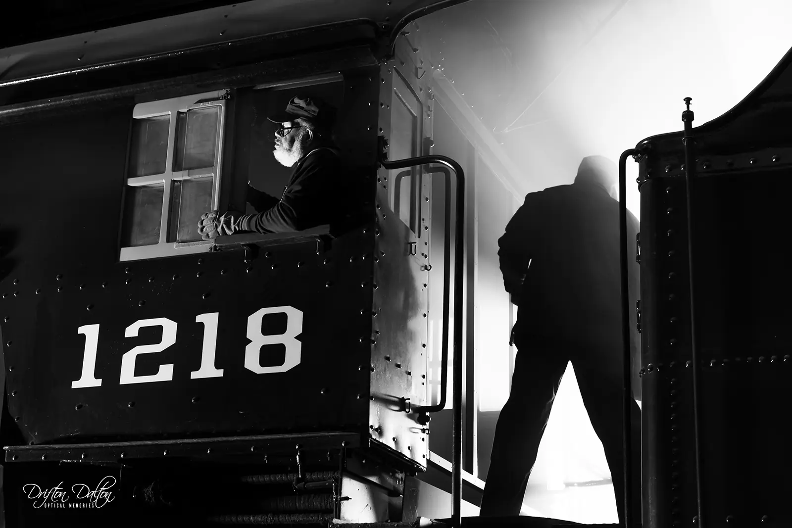 Staged black-and-white scene of crew members aboard Norfolk and Western 1218