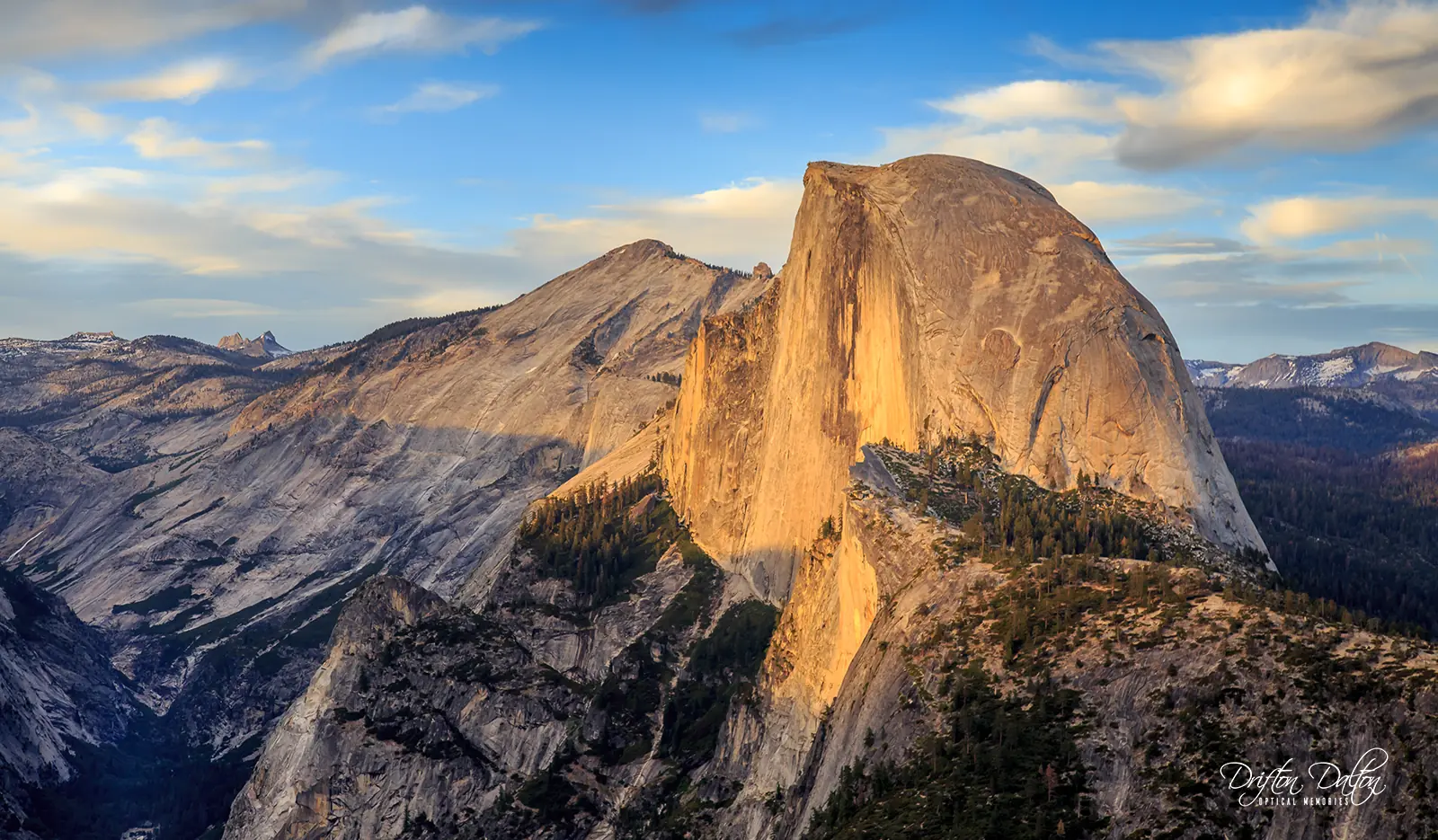 Half Dome glowing in warm light above Yosemite’s granite ridges