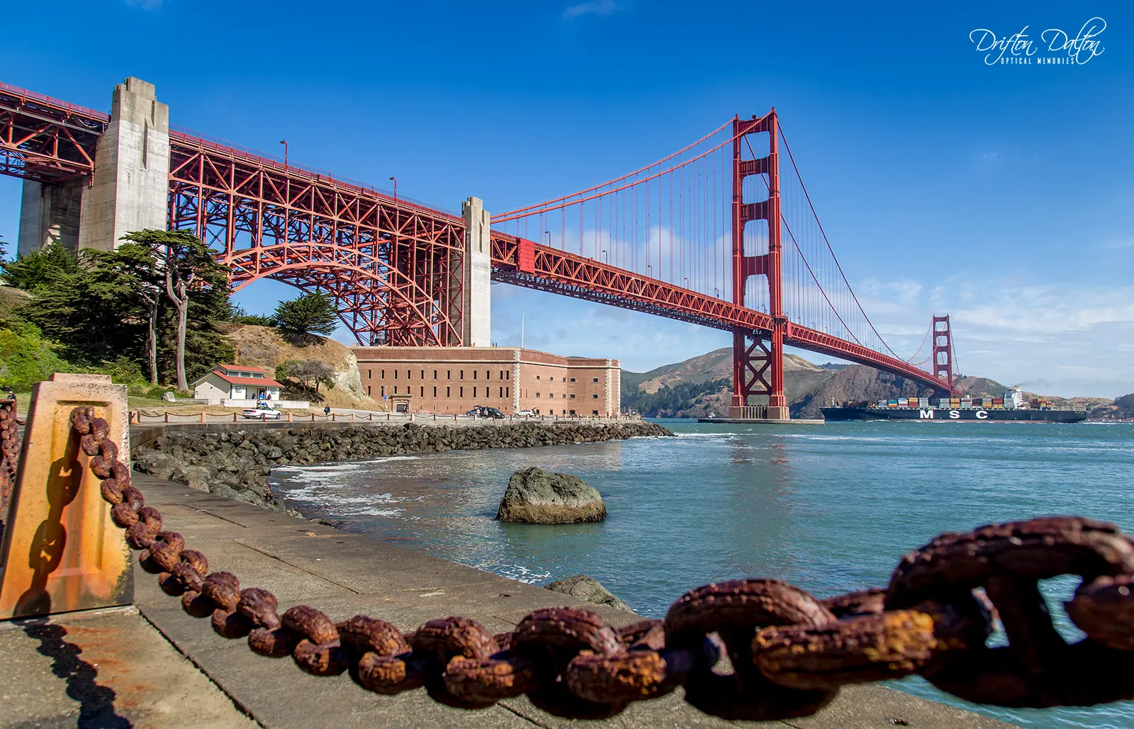 Golden Gate Bridge viewed across the water under a clear blue sky