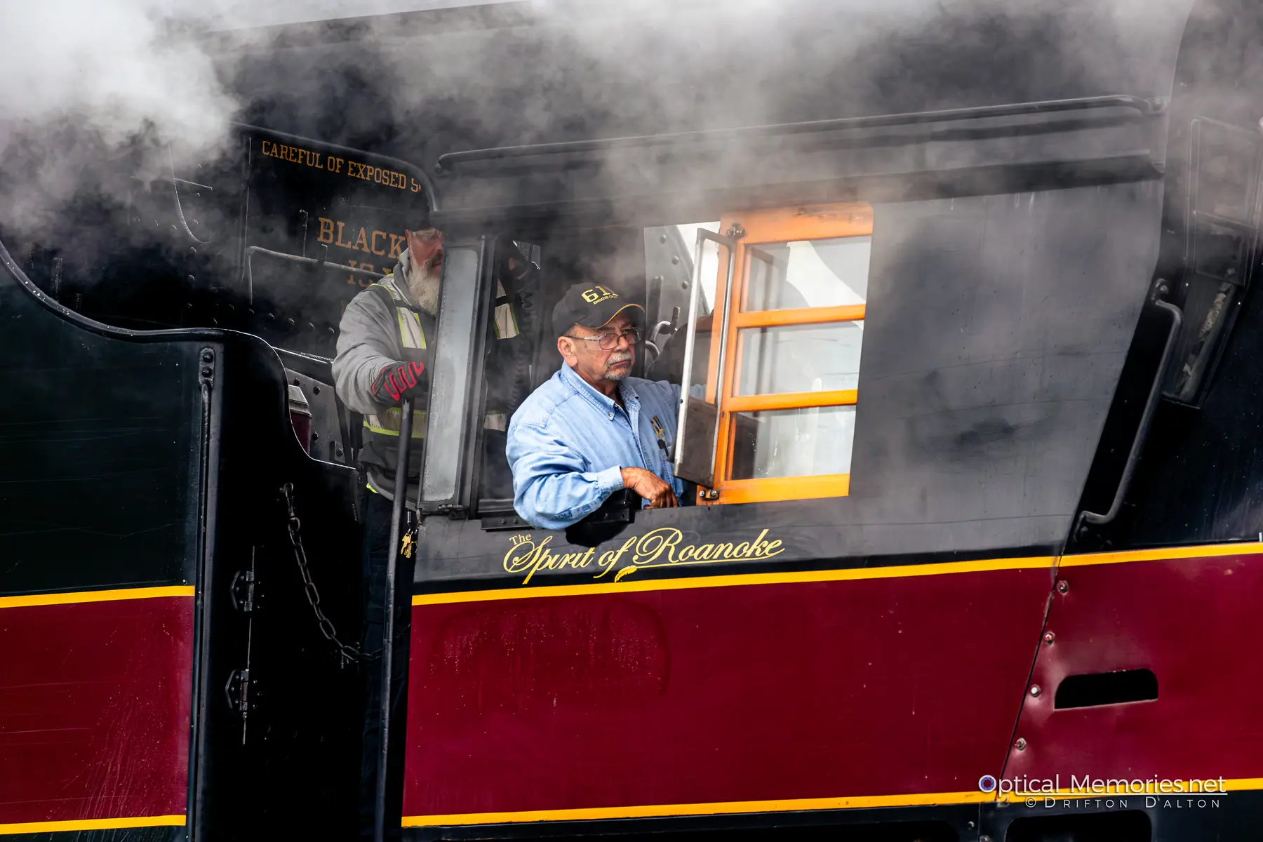 Crew member in the cab of Norfolk and Western 611 surrounded by drifting steam